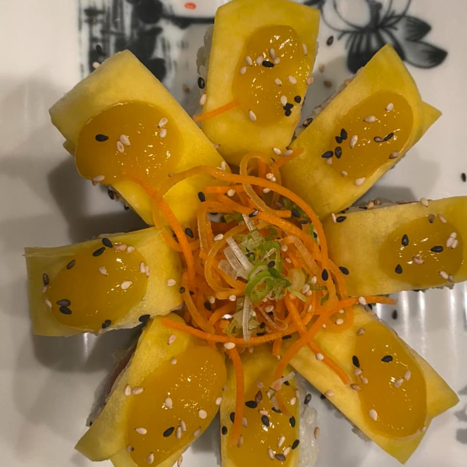 Yama Fuji's mango sushi roll, garnished with shredded carrots, green onions, and sesame seeds.