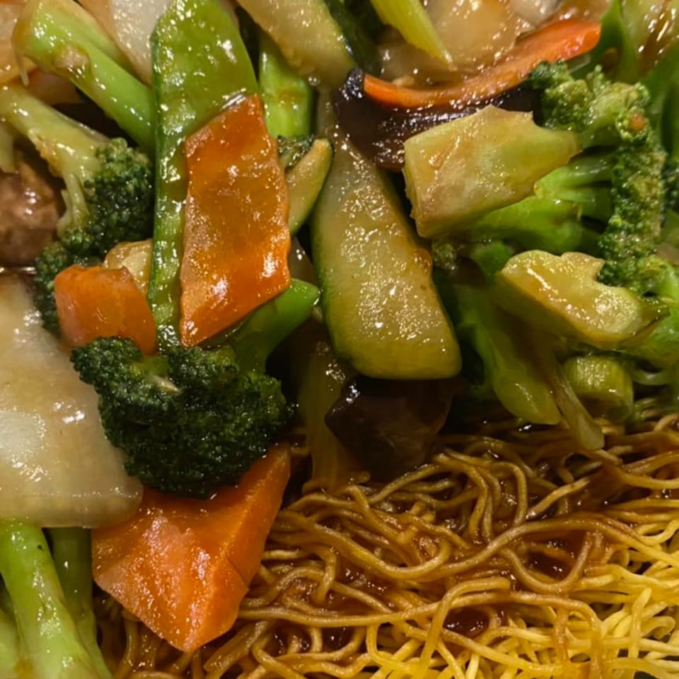 Close-up of Yama Fuji's Asian stir-fried vegetables with broccoli, carrots, and noodles.